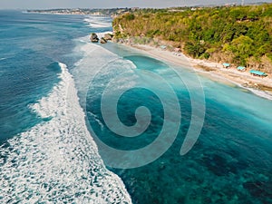 Aerial view of waves in ocean and coastline with Thomas beach in Bali