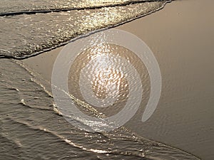 Aerial view of waves and sea with the reflection of Guzhen, Zhongshan during the sunset