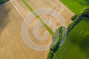 Aerial view ,Wheat field with straw bales after harvest. Sunflower crop. Small country side town landscape