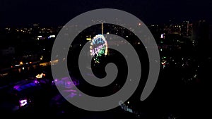 Aerial view of the wheel of fortune at night at the park. Clip. This is one of the world`s largest mobile Ferris wheels