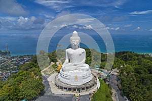 Aerial view.white Big Buddha statue on blue sky and blue ocean.This Big Buddha is the one of landmarks on Phuket island. photo