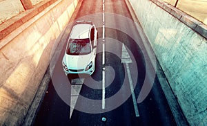 Aerial view of white car entering underground garage