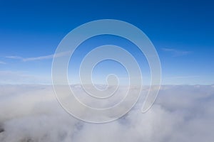 Aerial view White clouds in blue sky. View from drone. Aerial top view cloudscape. Texture of clouds. View from above. Sunrise or