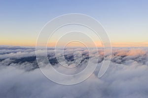 Aerial view White clouds in blue sky. View from drone. Aerial top view cloudscape. Texture of clouds. View from above. Sunrise or