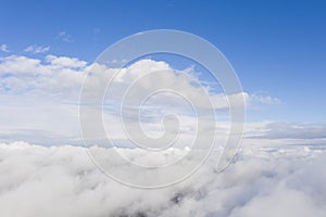 Aerial view white clouds in blue sky. View from drone. Aerial top view cloudscape. Texture of clouds. View from above. Sunrise orA