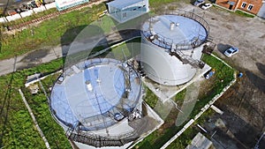 Aerial view white fuel storage tank in oil refinery plant. Stock. Top view white Industrial tanks for petrol and oil