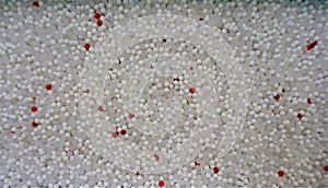 Aerial view of white, gray, red plastic microbeads photo