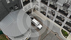 Aerial view white limousine jeep that pulls into the house