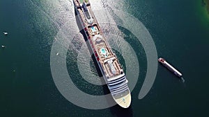 Aerial view of White luxury cruise ship docked in beautiful Caribbean sea close to the beach.