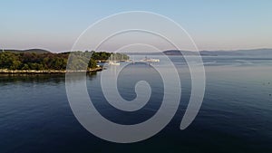 Aerial view of white luxury yachts and sailboats embarked in bay in Croatia, France, Greece, Ibiza, Italy, Europe.