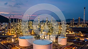 Aerial view white oil storage tank and oil refinery factory plant at night form industry zone, Oil refinery and petrochemical