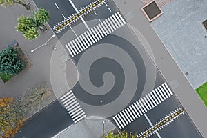 Aerial view of white pedestrian crossings on modern city street