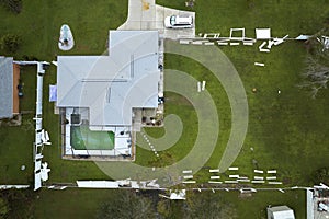 Aerial view of white plastic backyard fence damaged after hurricane Ian in Florida