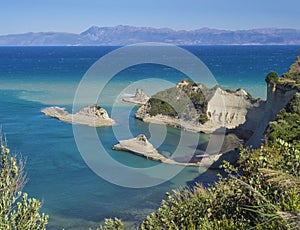 Aerial view on of white rock steep cliff volcanic bay of Cape Drastis and Peroulades area with tropical deep turquoise clear sea,