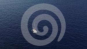 Aerial view on white sailing yacht floating across Mediterranean sea. Lipari Islands. Sicily, Italy