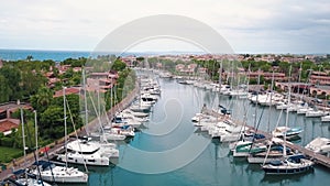 Aerial view on white sailing yachts at Portorosa, Furnari, Italy. Mediterranean sea, horizon and blue sky. Buildings