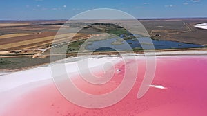 Aerial view of White salt on the shores of the island in Pink Island and blue sky . Lake Lemuria, Ukraine. Lake