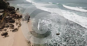 Aerial view of white sand beach, cliffs and waves in the coastal area of Gunung Kidul Yogyakarta, Indonesia