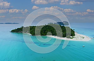 Aerial view of white sand beach tropical with seashore as the island in a coral reef ,blue and turquoise sea Amazing nature