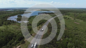 Aerial View of White Truck Passing Busy highway/ Highway Overpass/ Overdrive/ Bridge. Cars and trucks go on the road on