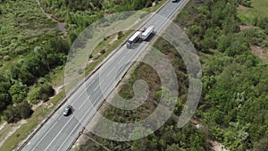 Aerial View of White Truck Passing Busy highway/ Highway Overpass/ Overdrive/ Bridge. Cars and trucks go on the road on