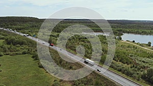 Aerial view of white truck passing busy highway/ highway overpass/ overdrive/ bridge. Cars and trucks go on the road on