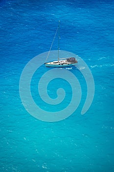 Aerial view of white yacht in deep blue sea