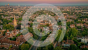 Aerial view of the Whitestone Walk, Hampstead with tall buildings and trees at sunset