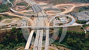 Aerial view of wide highway with a big roundabout and a bridge