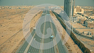 Aerial view of a wide straight highway in Dubai, UAE