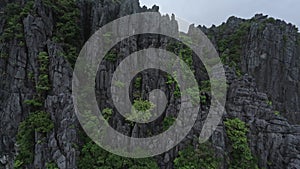 Aerial view wild island cliff formation covered by tropical plant rock texture sea ocean landscape