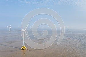 Aerial view of wind farm on mud flats wetland