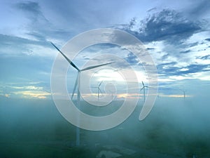 Aerial view Wind turbines and fog for generating electricity in Southeast Asia.