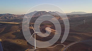 Aerial view of Wind Turbines generating green energy. Sunset and beautiful colours