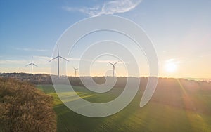 Aerial view of wind turbines in a green field in Giessen, Germany