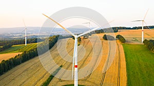 Aerial view of wind turbines and windmills in the field. Alternative green electrical energy generation.