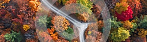 aerial view of winding hiking path, vibrant fall colors, captivating banner background with ample copy space