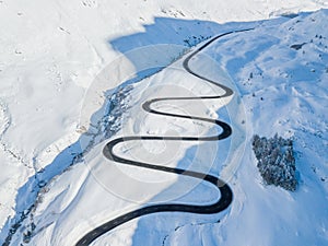Aerial view of the winding road over the Julier Pass in Swiss Alps mountain in winte photo