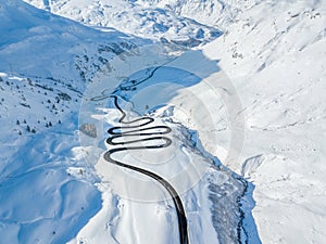 Aerial view of the winding road over the Julier Pass in Swiss Alps mountain in winter photo