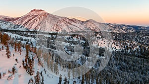 Aerial view of a winding road in snow covered mountains