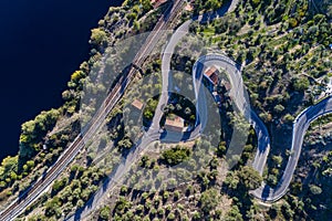 Aerial view of a winding road and train tracks along the Tagus River near the village of Belver in Portugal