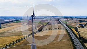 Aerial view of windmill against blue sky with clouds.