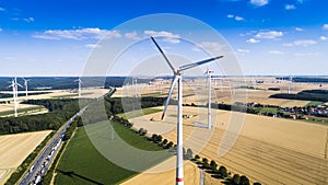 Aerial view of windmill against blue sky with clouds.