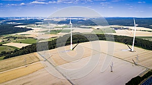 Aerial view of windmill against blue sky with clouds.