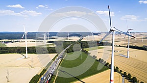 Aerial view of windmill against blue sky with clouds.