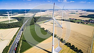 Aerial view of windmill against blue sky with clouds.