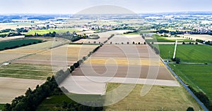 Aerial view of windmill against blue sky with clouds.