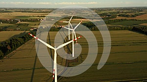 Aerial view windmills rotating under force wind and generating renewable energy
