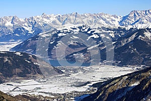 Aerial view of winter Austria village, Zell am See lake and sunny Alp mountains photo