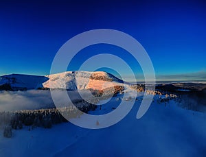 Aerial view of the winter background with a snow covered forest